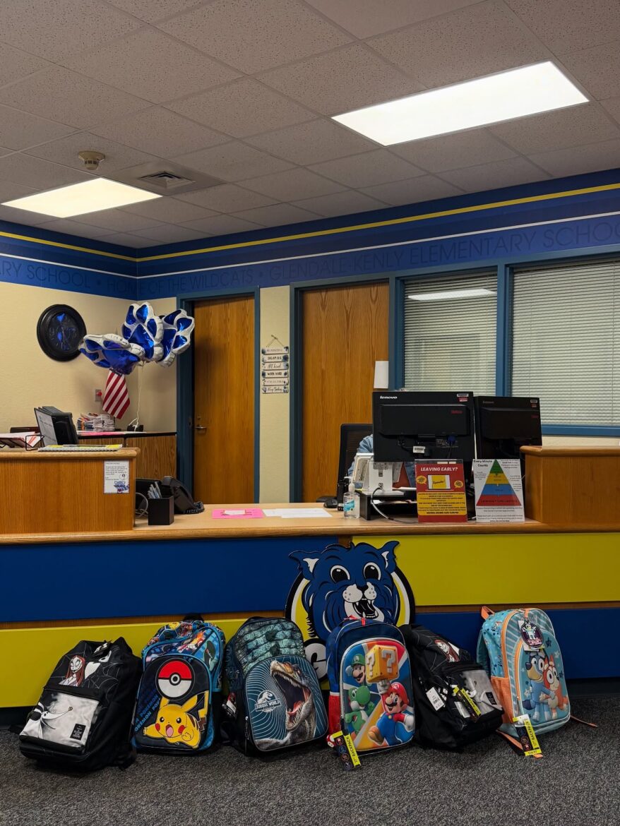 Row of colorful backpacks donated by Neuse River Homes displayed in the front office of Glendale-Kenly Elementary School